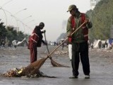Cleaners sweep a street after supporters of Tahirul Qadri left the capital. PHOTO: REUTERS